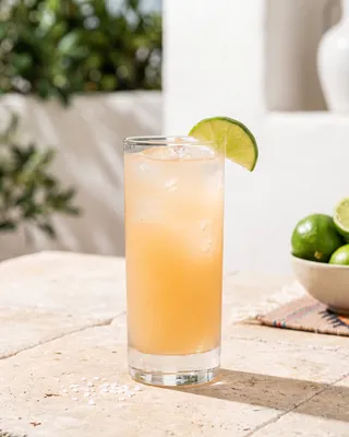 Paloma in a highball glass with lime