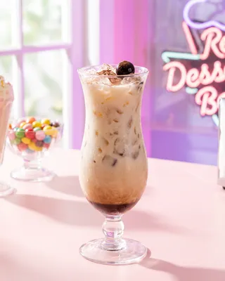 Screaming Orgasm in a hurricane glass with a cocktail cherry