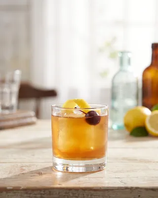 Scotch Sour in a rocks glass with lemon and a cocktail cherry