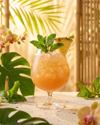 Missionary's Downfall in a snifter with mint and pineapple