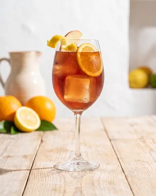 Sangria 43 in a wine glass with lemon, apple and orange