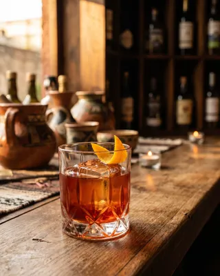 Negroni Latino in a rocks glass with orange