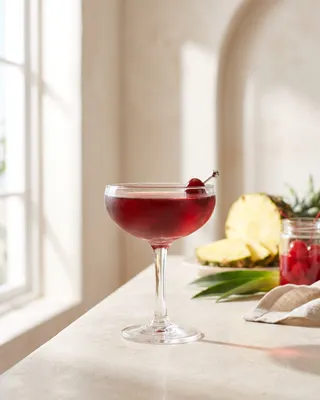 Mary Pickford in a coupe with a cocktail cherry