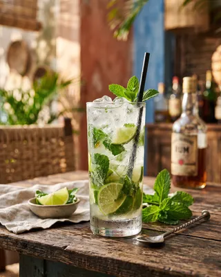 Mojito cocktail with lime, rum and mint served in a tall glass