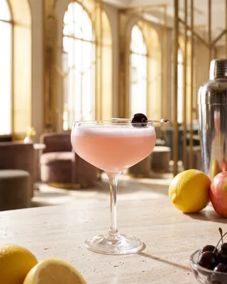 Pink Lady in a coupe with a cocktail cherry