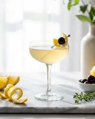 Tuxedo Cocktail in a coupe with lemon and a cocktail cherry